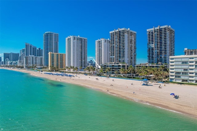 birds eye view of property featuring a view of the beach and a water view