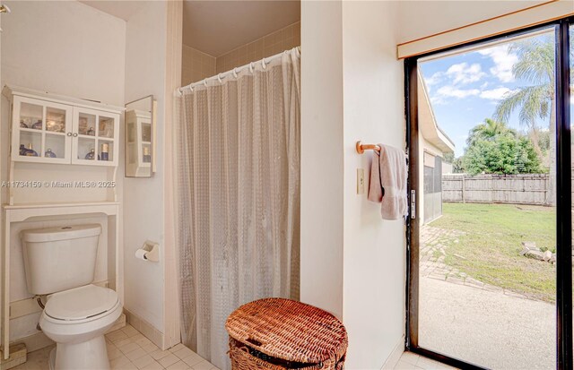 bathroom with walk in shower, toilet, and tile patterned flooring