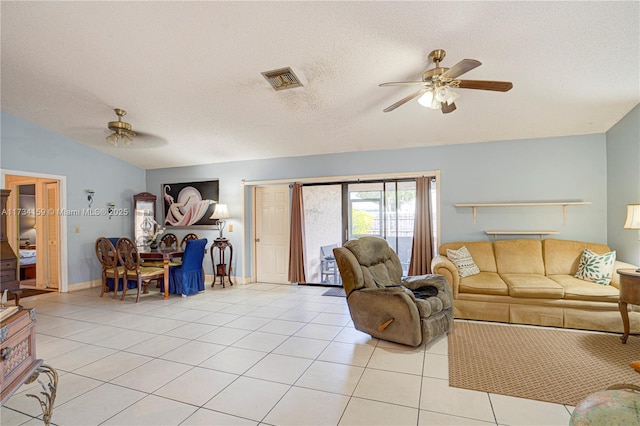 tiled living room with a textured ceiling, vaulted ceiling, and ceiling fan