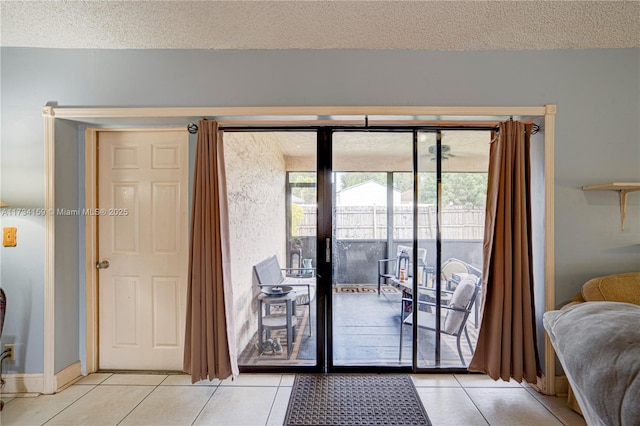 doorway with light tile patterned floors and a textured ceiling