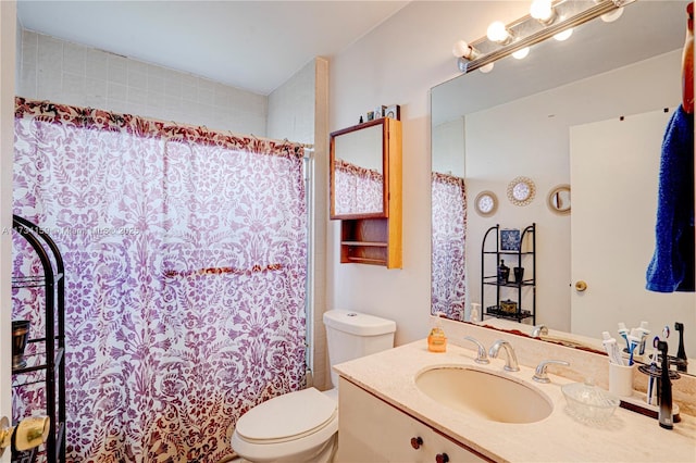 bathroom with vanity, toilet, and walk in shower