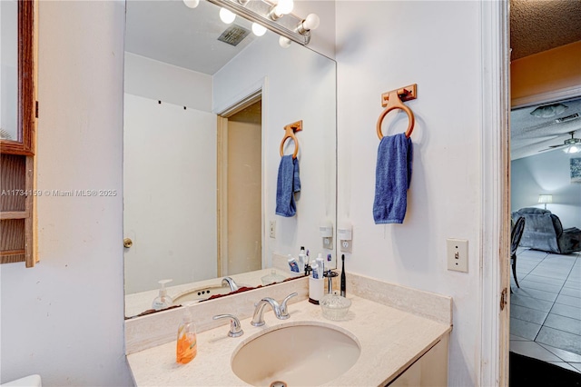 bathroom featuring tile patterned floors, vanity, and a textured ceiling