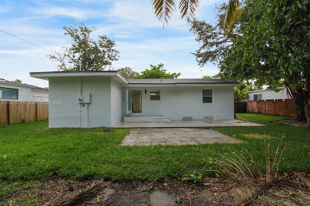 back of house featuring a yard and a patio area