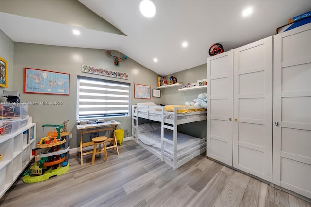 bedroom featuring vaulted ceiling and light hardwood / wood-style flooring