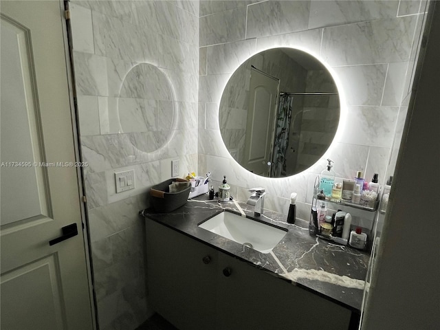 bathroom featuring tasteful backsplash, vanity, tile walls, and a shower with shower curtain