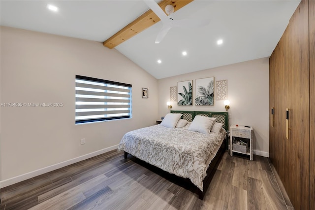 bedroom featuring ceiling fan, hardwood / wood-style floors, and vaulted ceiling with beams