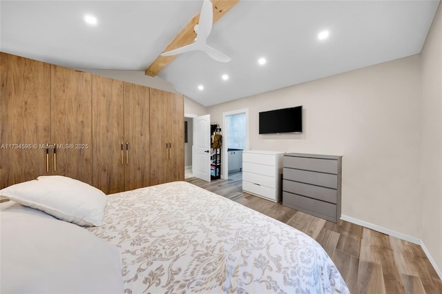 bedroom with ceiling fan, light hardwood / wood-style floors, and lofted ceiling with beams