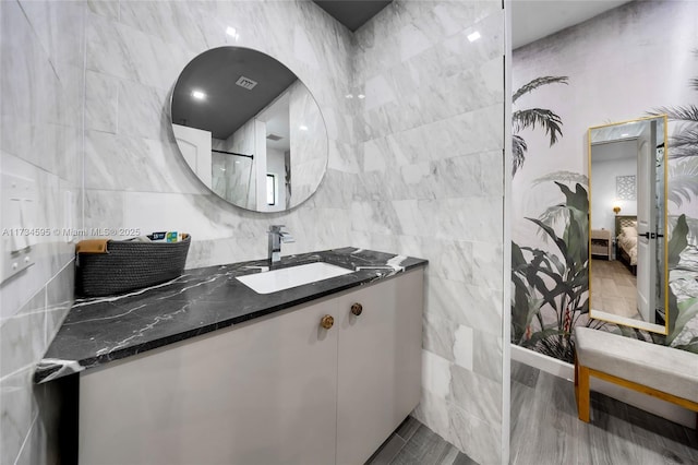 bathroom with tile walls and vanity