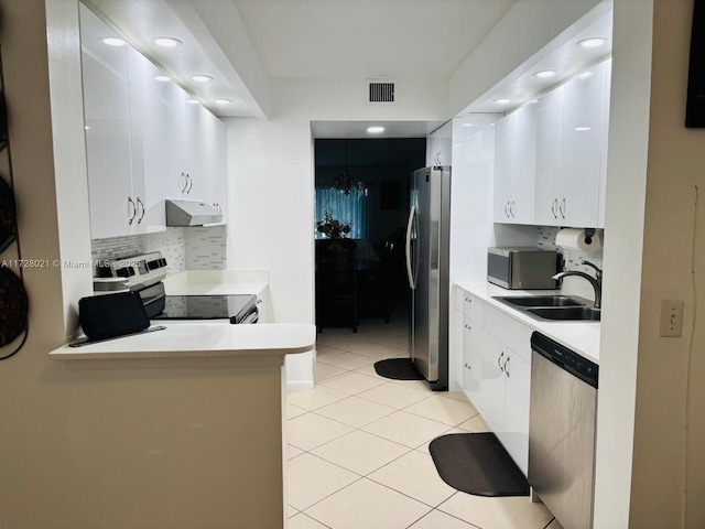 kitchen featuring tasteful backsplash, appliances with stainless steel finishes, sink, and white cabinets