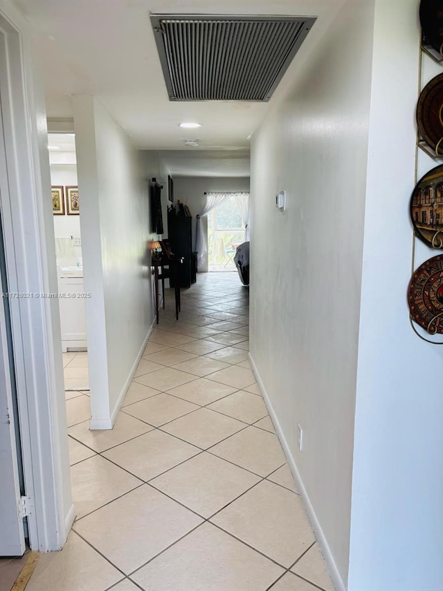 hall with light tile patterned floors