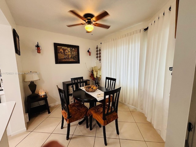 dining space with light tile patterned flooring and ceiling fan