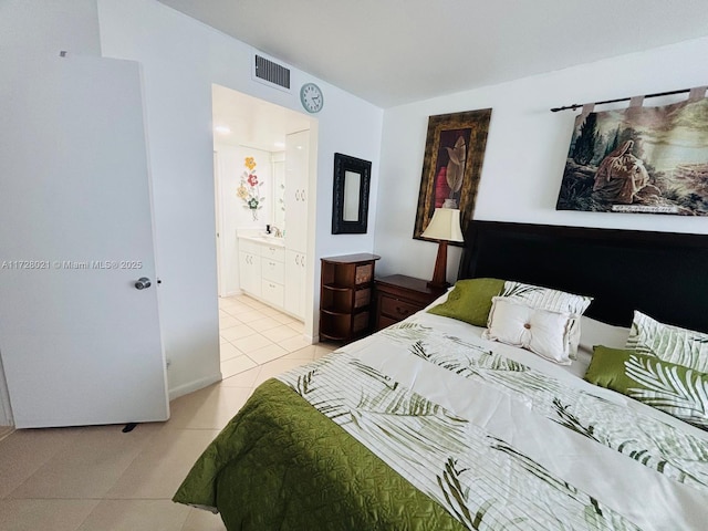 tiled bedroom with connected bathroom and sink