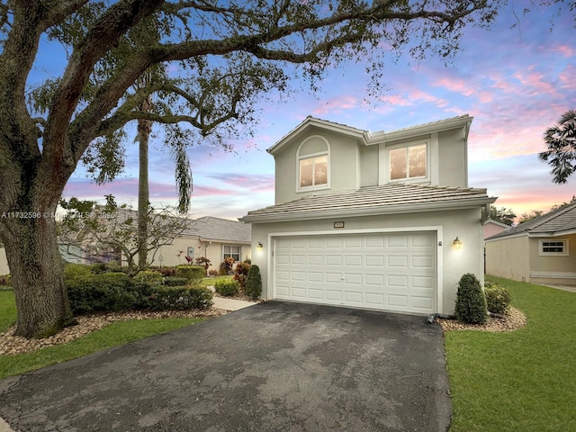 front facade featuring a yard and a garage