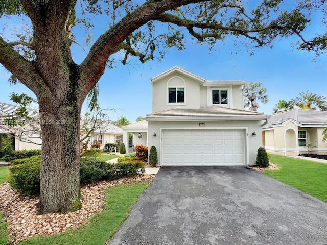 front of property featuring a garage and a front lawn