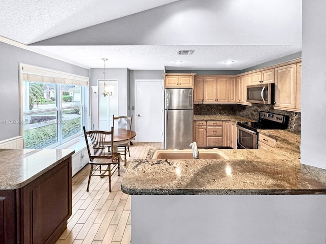 kitchen with vaulted ceiling, backsplash, kitchen peninsula, stainless steel appliances, and a textured ceiling