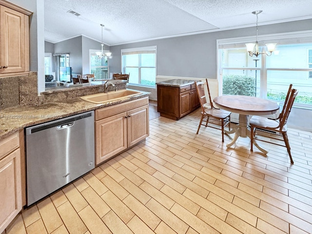 kitchen featuring an inviting chandelier, sink, pendant lighting, and stainless steel dishwasher