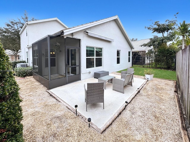 rear view of property with a sunroom, a lawn, and a patio area