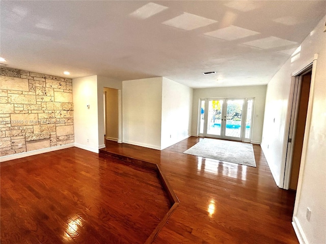 spare room featuring hardwood / wood-style flooring and french doors