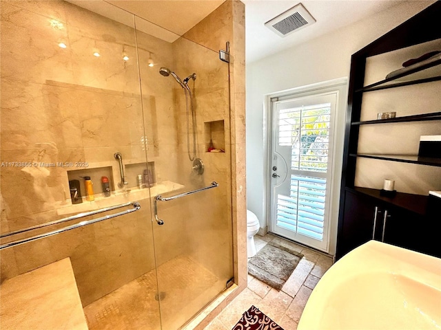 bathroom featuring an enclosed shower and toilet