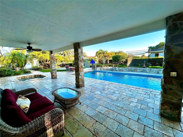 view of pool with ceiling fan and a patio