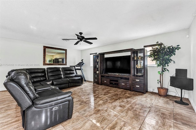 living room featuring a textured ceiling and ceiling fan