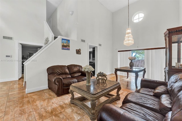 living room with a notable chandelier and a high ceiling