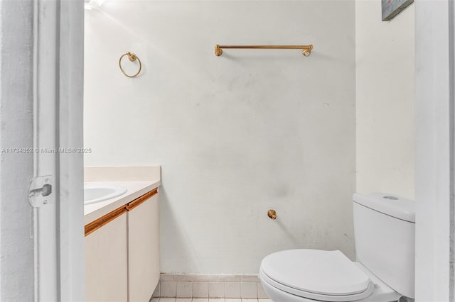 bathroom with tile patterned flooring, vanity, and toilet