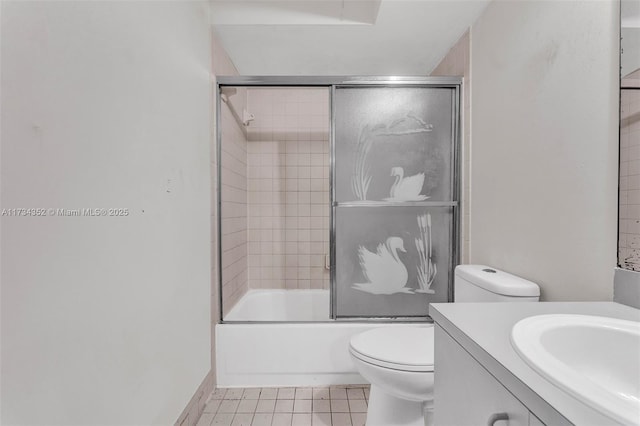 full bathroom featuring enclosed tub / shower combo, vanity, tile patterned flooring, and toilet