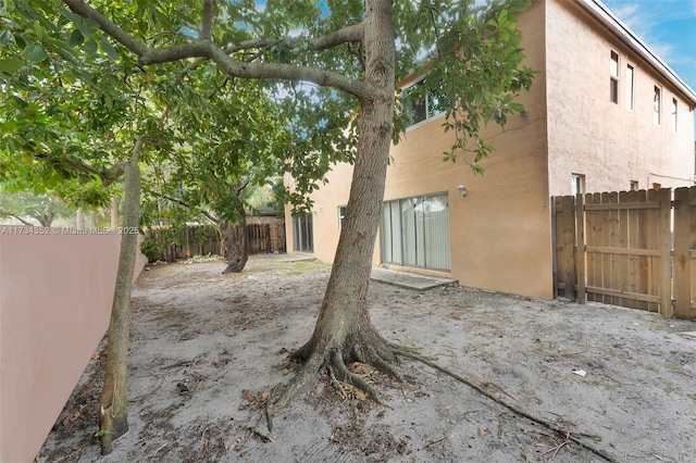 9500 Atlantic St, Miramar, FL 33025 - back of property with stucco siding, a fenced backyard, and a patio