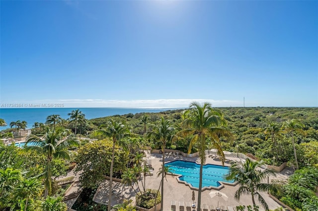 view of pool with a patio and a water view