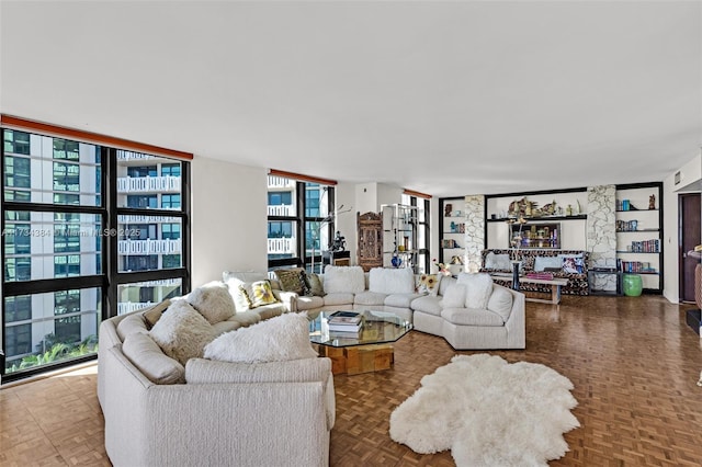 living room featuring floor to ceiling windows and parquet floors