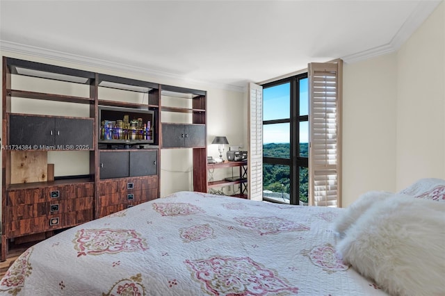 bedroom featuring ornamental molding and expansive windows