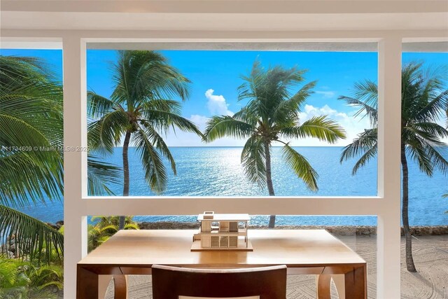 view of pool with a water view and a beach view