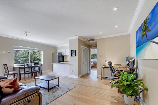 living room featuring crown molding and light wood-type flooring