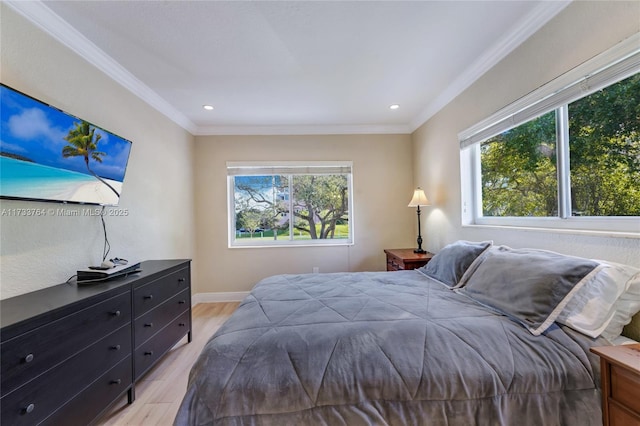 bedroom with crown molding and light hardwood / wood-style floors