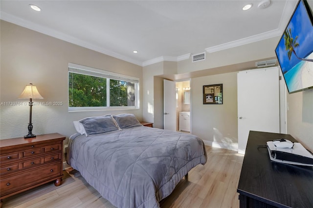 bedroom with crown molding, ensuite bathroom, and light wood-type flooring