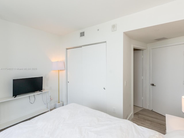 bedroom featuring light wood-type flooring and a closet