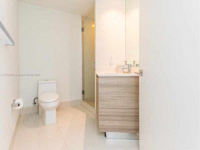 bathroom featuring tile patterned flooring, vanity, toilet, and walk in shower