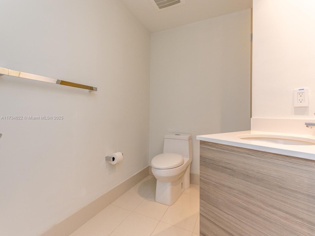 bathroom featuring tile patterned flooring, vanity, and toilet