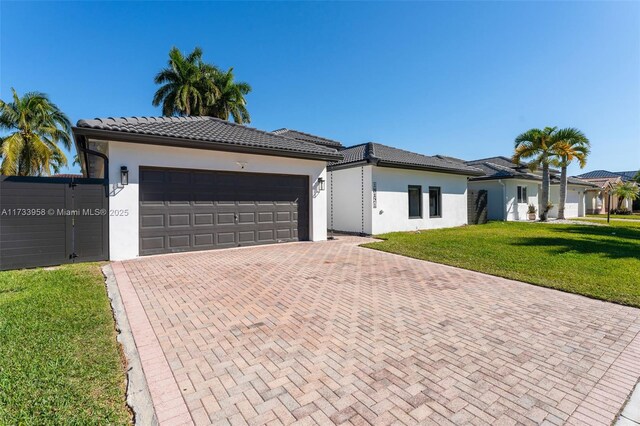 view of front of home with a garage and a front lawn