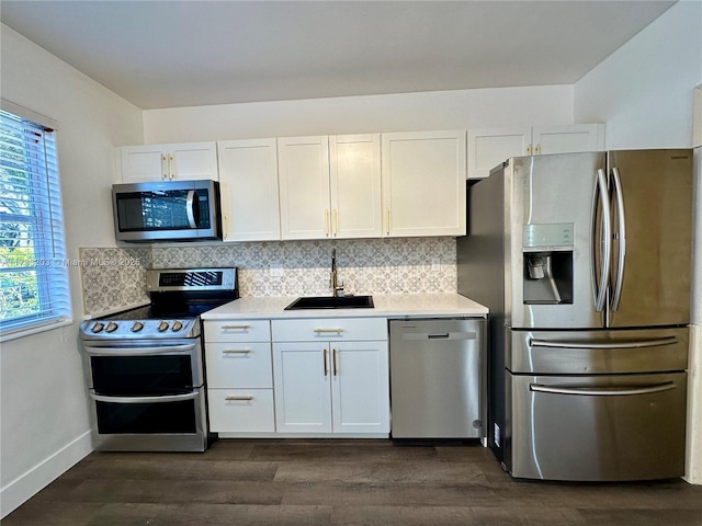 kitchen with sink, white cabinetry, tasteful backsplash, dark hardwood / wood-style floors, and stainless steel appliances