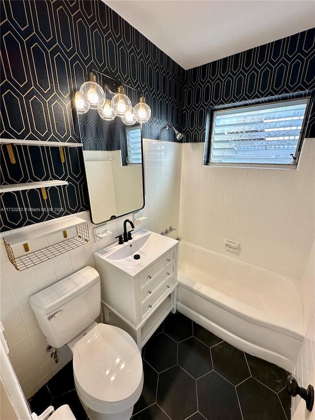 bathroom featuring vanity, a bath, tile patterned floors, and toilet