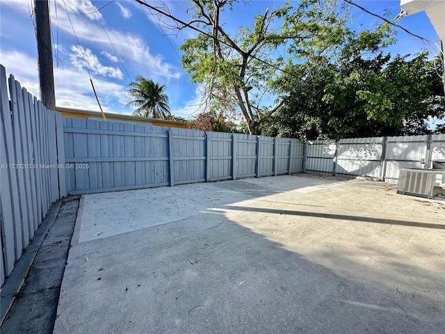 view of yard featuring central AC and a patio