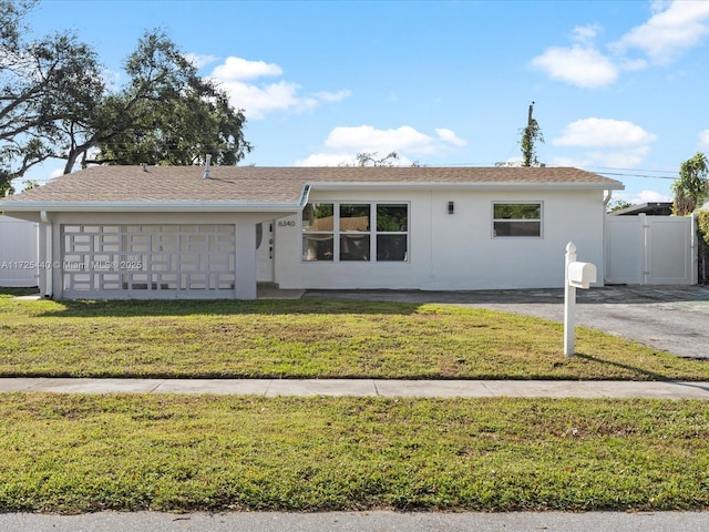 view of front of property featuring a garage and a front lawn