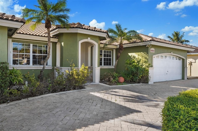 mediterranean / spanish house featuring a garage