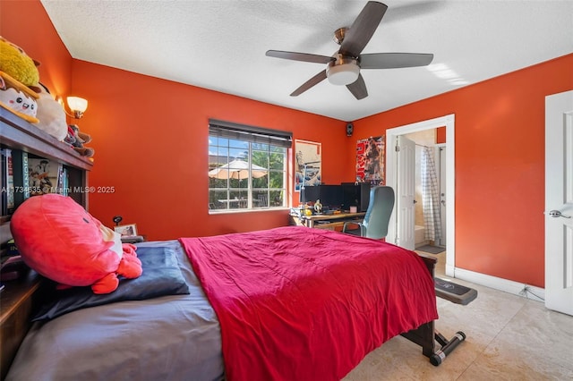 bedroom featuring ceiling fan, connected bathroom, and a textured ceiling