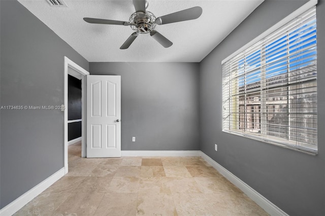 spare room with a textured ceiling