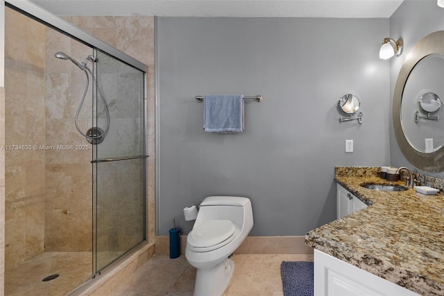 bathroom featuring vanity, toilet, tile patterned flooring, and a shower with door