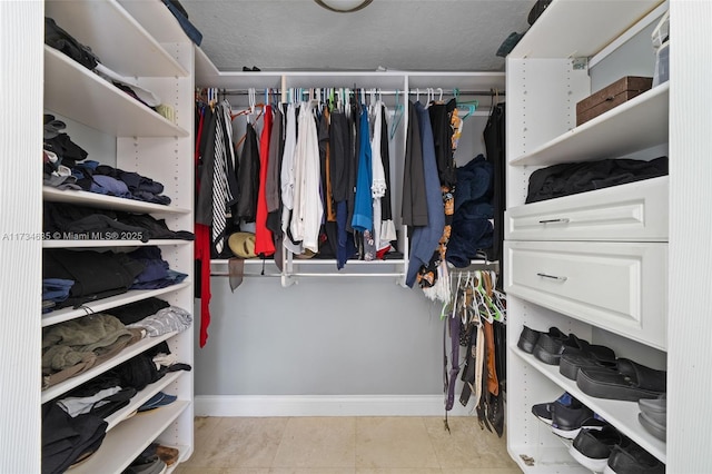 spacious closet featuring light tile patterned floors