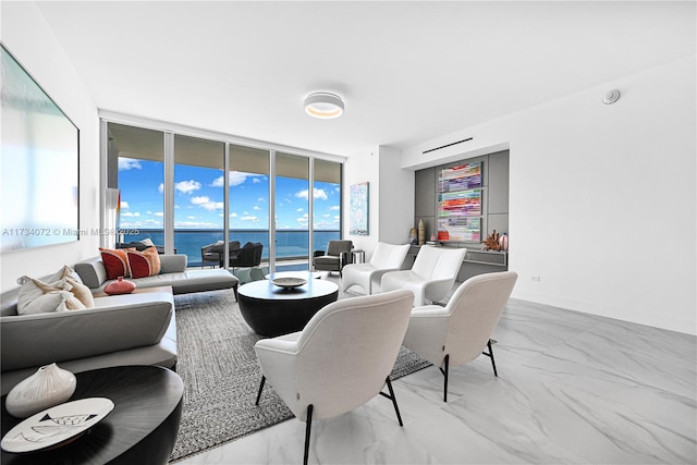 living room featuring a water view and expansive windows